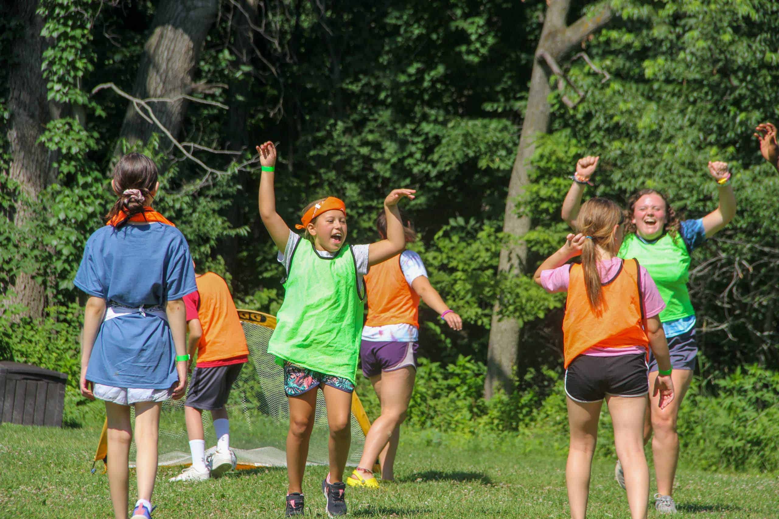 A group of kids playing frisbee at summer camp in Iowa.