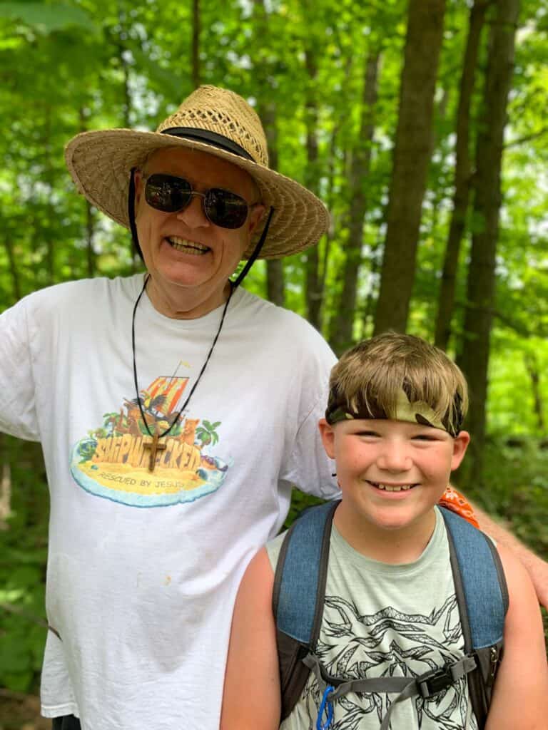 An older man and a young boy at a summer camp in Iowa.