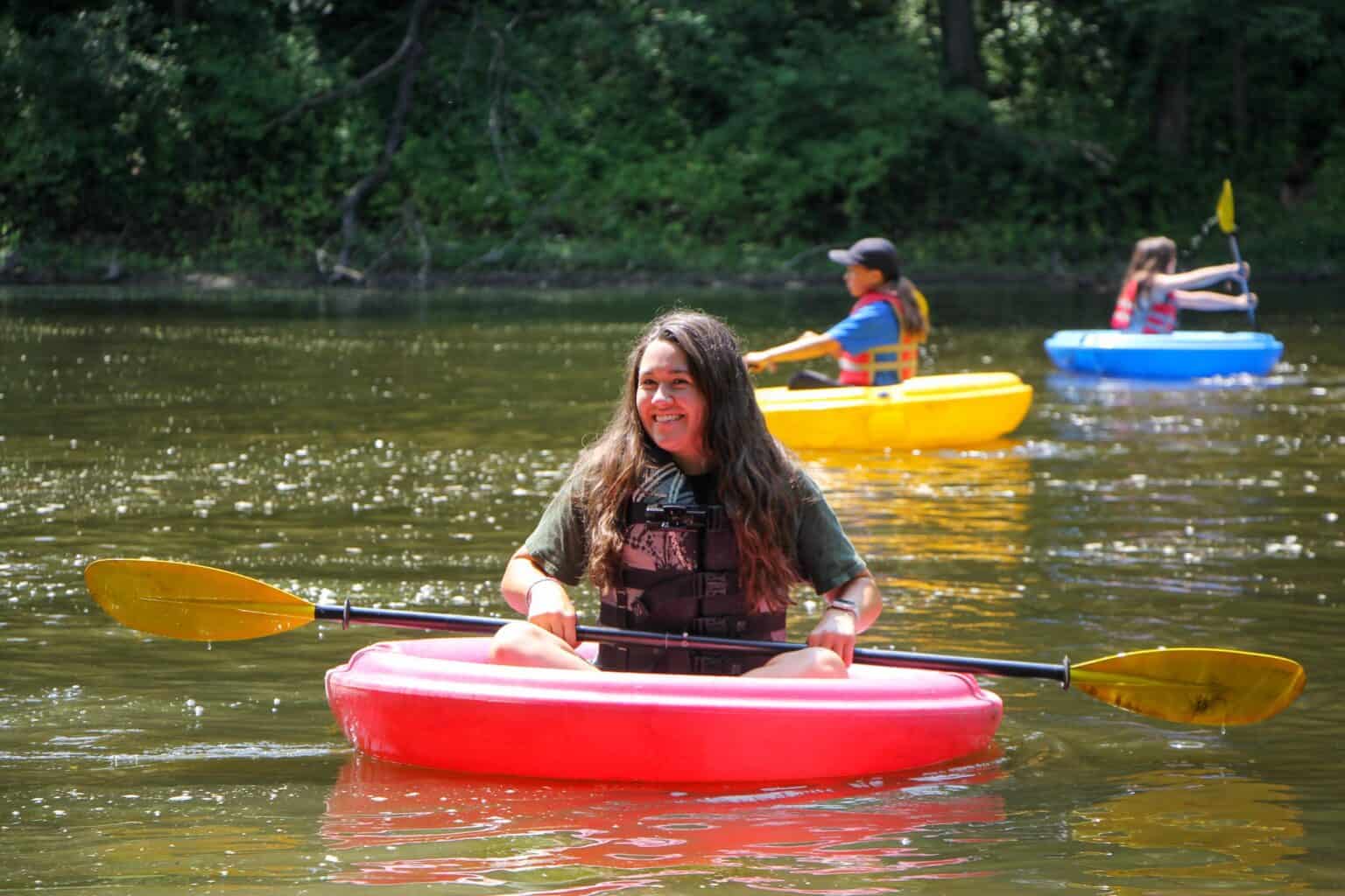 A girl in a kayak at an Iowa summer camp.