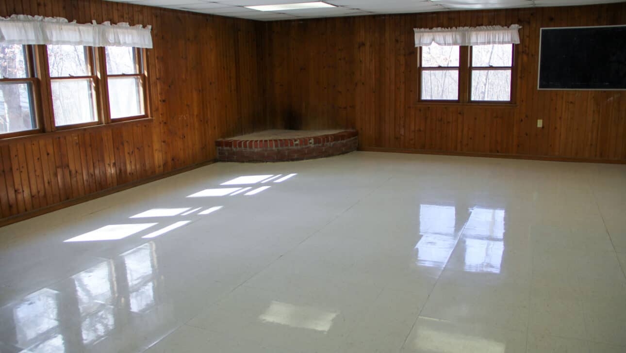 A white tiled floor in a summer camp cabin in Iowa.