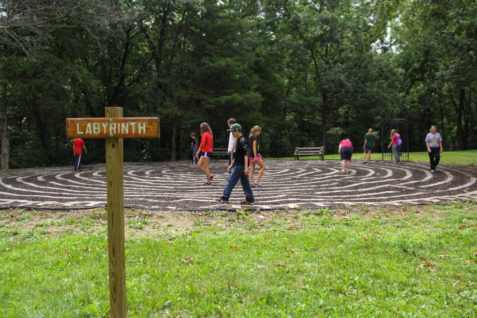 A group of kids walking around a labyrinth at an Iowa summer camp.